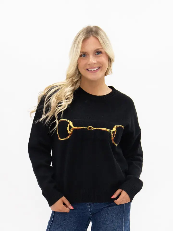 Gold Horse-Bit On A Black Sweater