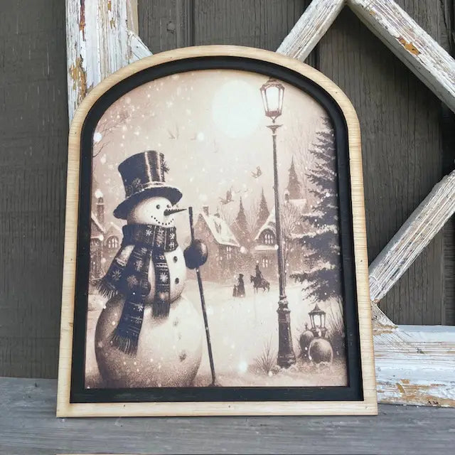 Snowman in Village with Horse and Lamp Post Framed Print