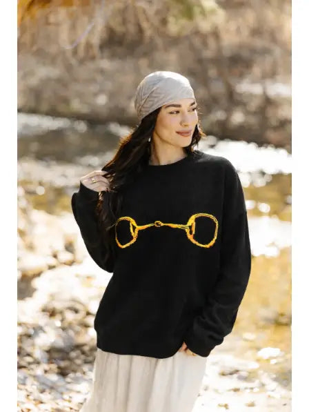 Gold Horse-Bit On A Black Sweater